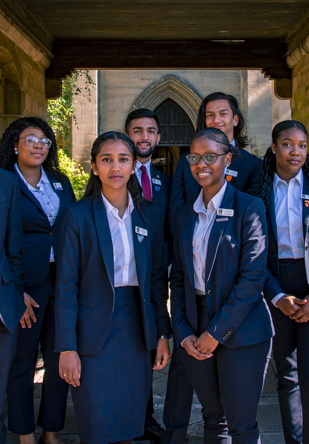 The sixth form student leadership team posing for their photo under the archway leading up to St Matthew's Church.
