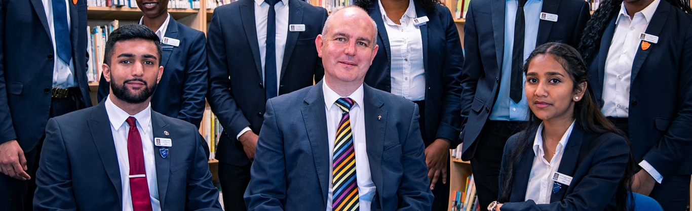 Mr Smith with fellow sixth form students in the library.